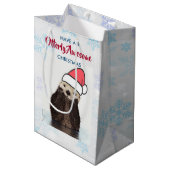 サンタハットのクリスマスプーンを着たかわいいカワウソ ミディアムペーパーバッグ (正面アングル)