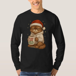 サンタ帽をかぶったおこったクリスマス猫 Tシャツ