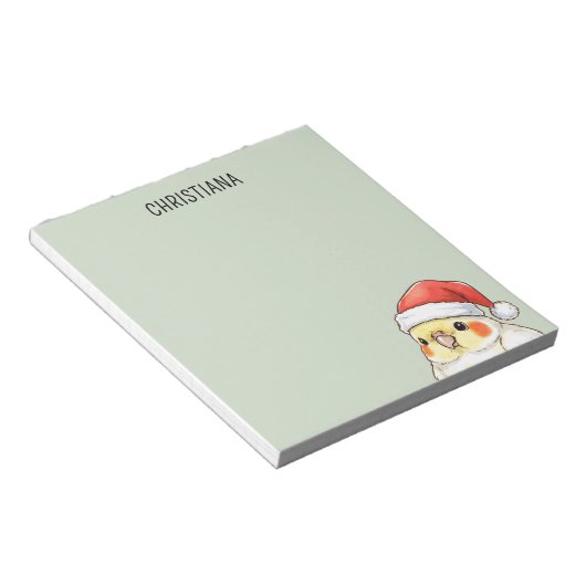 サンタ帽をかぶったオカメインコのクリスマスグッズ ノートパッド (アングル)