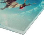 サンタ飛んでいるクロースとトナカイ カッティングボード (角)