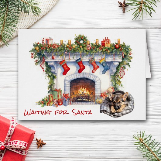 サンタ・暖炉でドイツの羊飼い子犬が待つ