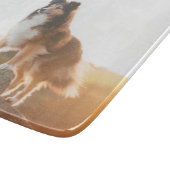 シェットランド・ シープドッグオン保護クリフの夕日の間に聞いた カッティングボード (角)