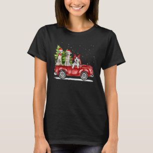 シベリアのハスキーサンタレッドトラック雪クリスマスツリー Tシャツ