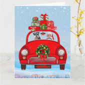 シュナウザーの犬がサンタクロースと一緒に車に乗っている カード (黄色い花)