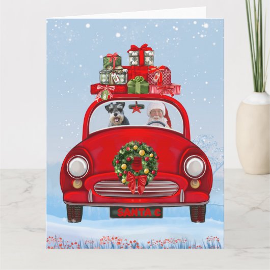 シュナウザーの犬がサンタクロースと一緒に車に乗っている カード (正面)