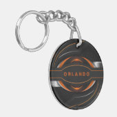 シルバー、ブラック、オレンジ色のジオメトリックゲーミングモノグラム キーホルダー (正面左)