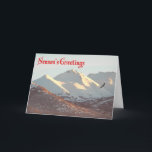 シーズンの挨拶 – Winter Eagle シーズンカード<br><div class="desc">ハゲのワシが、アンカレッジ近郊の雪に覆われたChugach Rangeの近くを飛ぶ。文字読の「シーズングリーティング」は赤で表示される。</div>