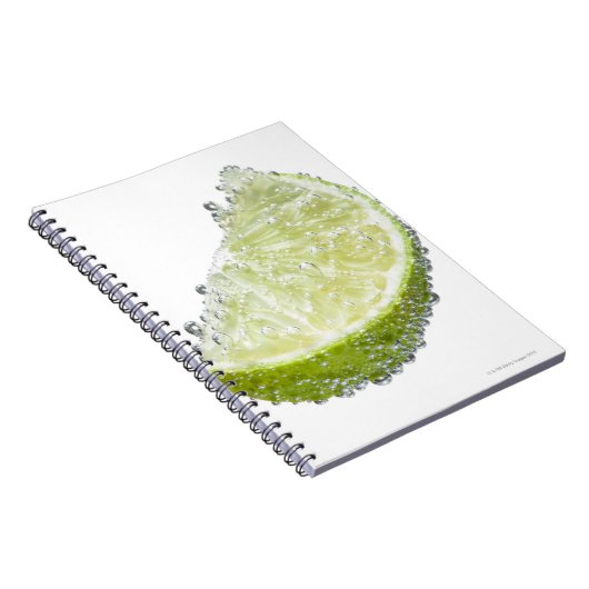 ジューシーな熟したオーガニックライムのくさび果実が水没した ノートブック (右側)