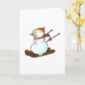 スキー帽とスキーを履いたスキー客としての雪だるま カード (黄色い花)