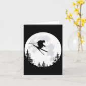 スキー – 飛んでいる月の上空をジャンプするスキーヤー カード (黄色い花)