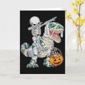 スケルトンに乗って踊るダブ巨大恐竜T-Rexハロウィン カード (黄色い花)