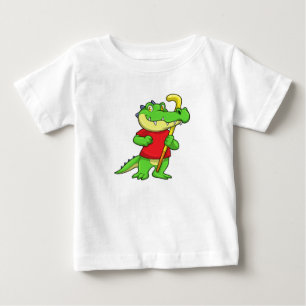 スティックとフィールドホッケーでクロコダイル ベビーTシャツ