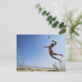 スパイクまで跳んでいるオスのビーチバレープレーヤー ポストカード (スタンド正面)