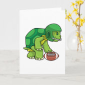 スポーツでヘルメットを被ったフットボールをするカメ カード (黄色い花)