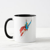 スーパーガールが高く舞い上がる マグカップ (左)