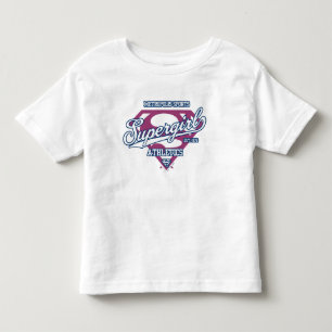 スーパーガールメトロポリススポーツ陸上競技グラフィック トドラーTシャツ