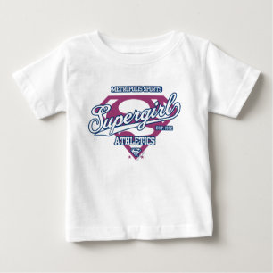 スーパーガールメトロポリススポーツ陸上競技グラフィック ベビーTシャツ
