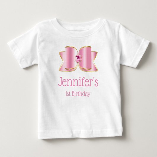 センターに宝石を飾ったピンクのグロスボウ 1歳の誕生日 ベビーTシャツ (正面)