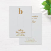 タイポグラフィはっきりした金ゴールドモノグラムヘアクリップの表示 (デスク)