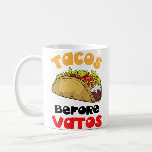 タコスはバトスより大切 コーヒーマグカップ (左)
