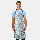 ダークグリーンとティール(緑がかった色)モンステラ離れのとライリーの輪郭 エプロン (着用した状態)