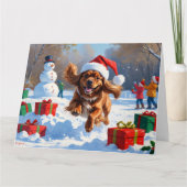 チベットのスパニエル犬走のクリスマス帽子と雪の中 カード (正面)