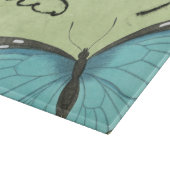 ティール(緑がかった色)の郵便はがきの青飛んだ蝶 カッティングボード (角)