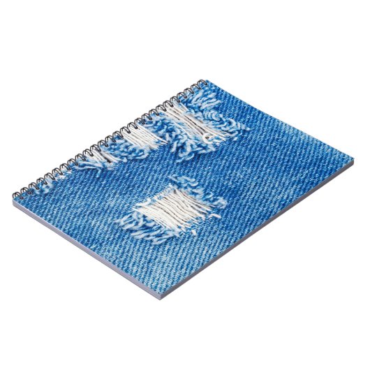 デニムジーンズに穴。破れた破れた青いjeを破った ノートブック (左側)