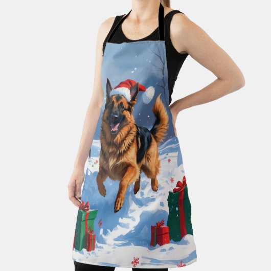 ドイツの走シェパードの雪とクリスマス帽子 エプロン