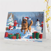 ドイツの走シェパードの雪とクリスマス帽子 カード (黄色い花)