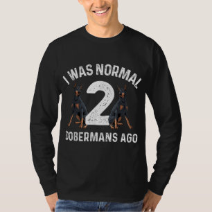 ドベカッコいいルマンアー男性へトウィメンズ(犬)ドーベルマン・ピンシェル Tシャツ