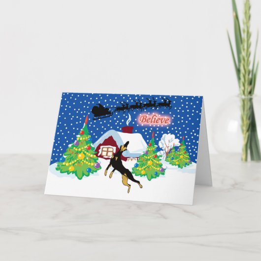 ドーベルマン犬はサンタのクリスマスで信じます シーズンカード (正面)