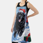 ニューファンドランド走のクリスマス帽子と雪の中にある エプロン (インサイチュ)