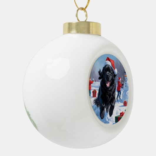 ニューファンドランド走のクリスマス帽子と雪の中にある セラミックボールオーナメント (左)