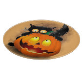 ネコおもしろいハロウィーンキャラクターカボチャをかむ カッティングボード (角)