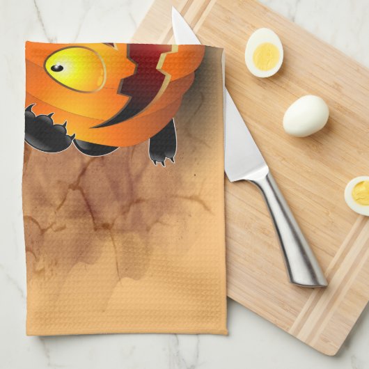 ネコおもしろいハロウィーンキャラクターカボチャをかむ キッチンタオル (四つ折り)