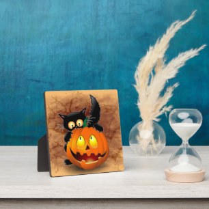ネコおもしろいハロウィーンキャラクターカボチャをかむ フォトプラーク