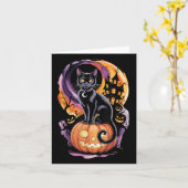 ハロウィンの満月下でかぼちゃと一緒にいる黒猫 カード (黄色い花)