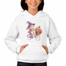 ハロウィンの魔女に扮したうさぎがカボチャの自転車に乗る