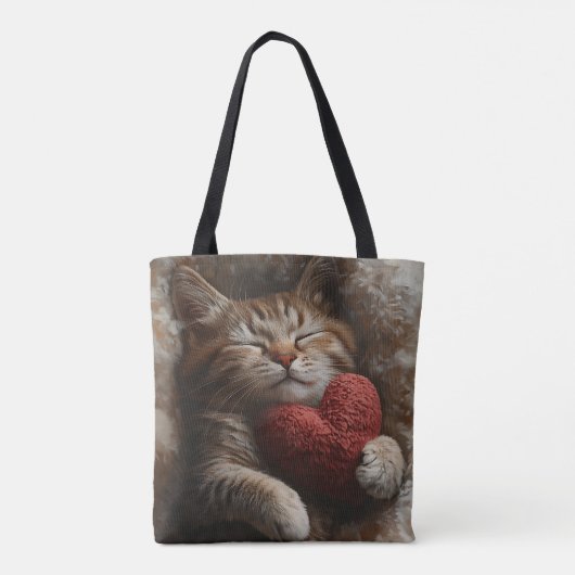 ハート型の枕を持つ眠るオレンジのタビー猫 トートバッグ (裏面)
