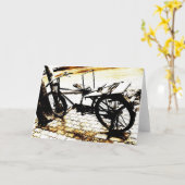 バイクに乗る – セピア調のレトロ カード (黄色い花)