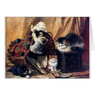 バスケットの旧式な絵画と遊んでいる子ネコ