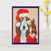 バセット・ハウンドの子犬がサンタにクリスマスの願い事を伝える カード (黄色い花)