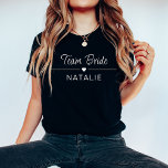 バチェロレッテチームブライドパーソナライズされたブライダル Tシャツ<br><div class="desc">Team BrideのブライダルTシャツでバチェロレッテスタイルを高めパーソナライズされた、シックでダークな色はっきりしたで、印象的な白いプリントで飾る。花嫁と分隊のためにデザインされたこのダークカラーのシャツは、おもしろいと一体感を維持しながら、お祝いに洗練されたtouchを加える。ハートのモチーフは中心のステージを取り、暗い背景と見事に対比し、花嫁の部族の中の愛とつながりを象徴する。白いカスタマイズプリントで花嫁の名前や特別なメッセージが入ったシャツが一つ一つエレガント、ブライダルパーティ全体が大切に思い出すパーソナライズされた形の形見を作り出す。素材を使っ高品質たバチェロレッテシャツは声明を作るだけでなく、お祭りスタイリッシュ全体の心地よいを提供する。新婦ギフトチーム新婦のシャツは、これらのInstagramに価値のある瞬間をキャプチャし、あなたの人々との永続的な思い出を作成するのに最適お気に入りのである。あなたはの夜の街での外出や花嫁チームとの日の予定などリラックスに、これらの名前をカスタムするバチェロレッテシャツは暗い色合いで、あなたのアンサンブルに洗練されたtouchを追加する。花嫁の分隊のシャツは団結の象徴であるだけでなく、あなたのプレパーソナライズされたの祭りにファッショナブルで結婚追加される。花嫁の提案や花嫁の贈り物として理想的な、白いプリントを持つこれらの暗い色のシャツはっきりしたは表現、あなたのブライダルパーティに感謝しながら声明を作る。スタイルでチームブライド祝に参加し、エレガンスと個性を楽に組み合わせお洒落たパーソナライズされたブライダルパーティシャツと一緒に大きな一日への旅。</div>