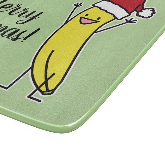 バナナのサンタの帽子の元気づけるクリスマスの休日 カッティングボード (角)