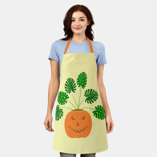 パンプキンのハロウィーンモンステラ植物 エプロン (着用した状態)