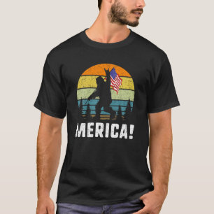 ビッグフット・メリカロックアンドロール米国国旗の森おもしろい Tシャツ
