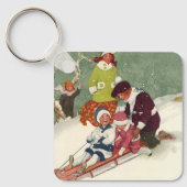 ビンテージクリスマス、雪の中で子供たちがスレッドに乗って遊ぶ キーホルダー (正面)