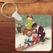 ビンテージクリスマス、雪の中で子供たちがスレッドに乗って遊ぶ キーホルダー (正面)