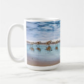 ビーチに沿って走っているシギ コーヒーマグカップ (左)